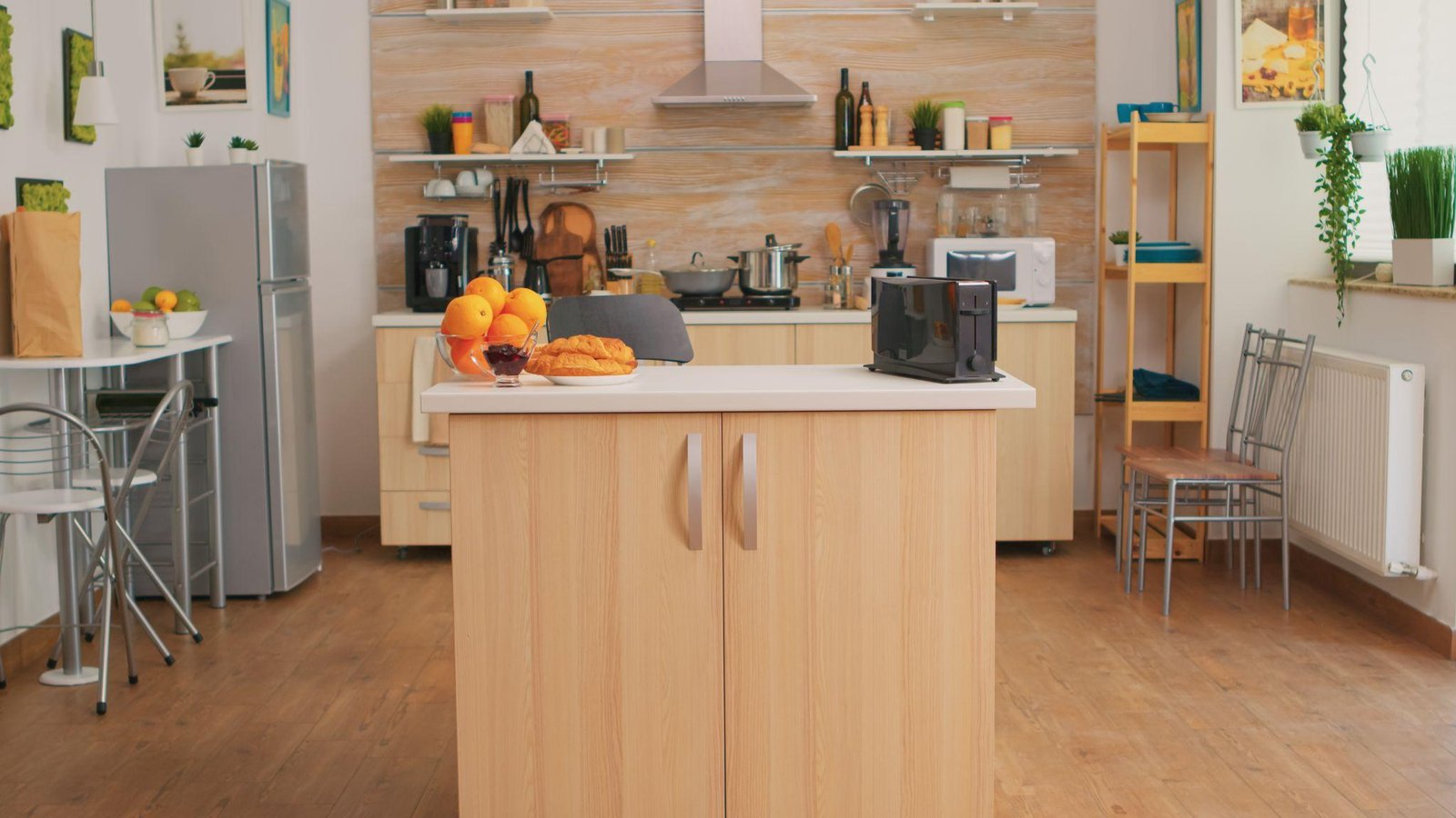 Kitchen with small appliances stored on open shelving and a run of base cabinets, keeping the island countertop clear