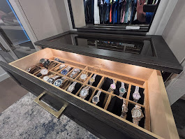 Illuminated watch drawer with velvet-lined compartments in closet island
