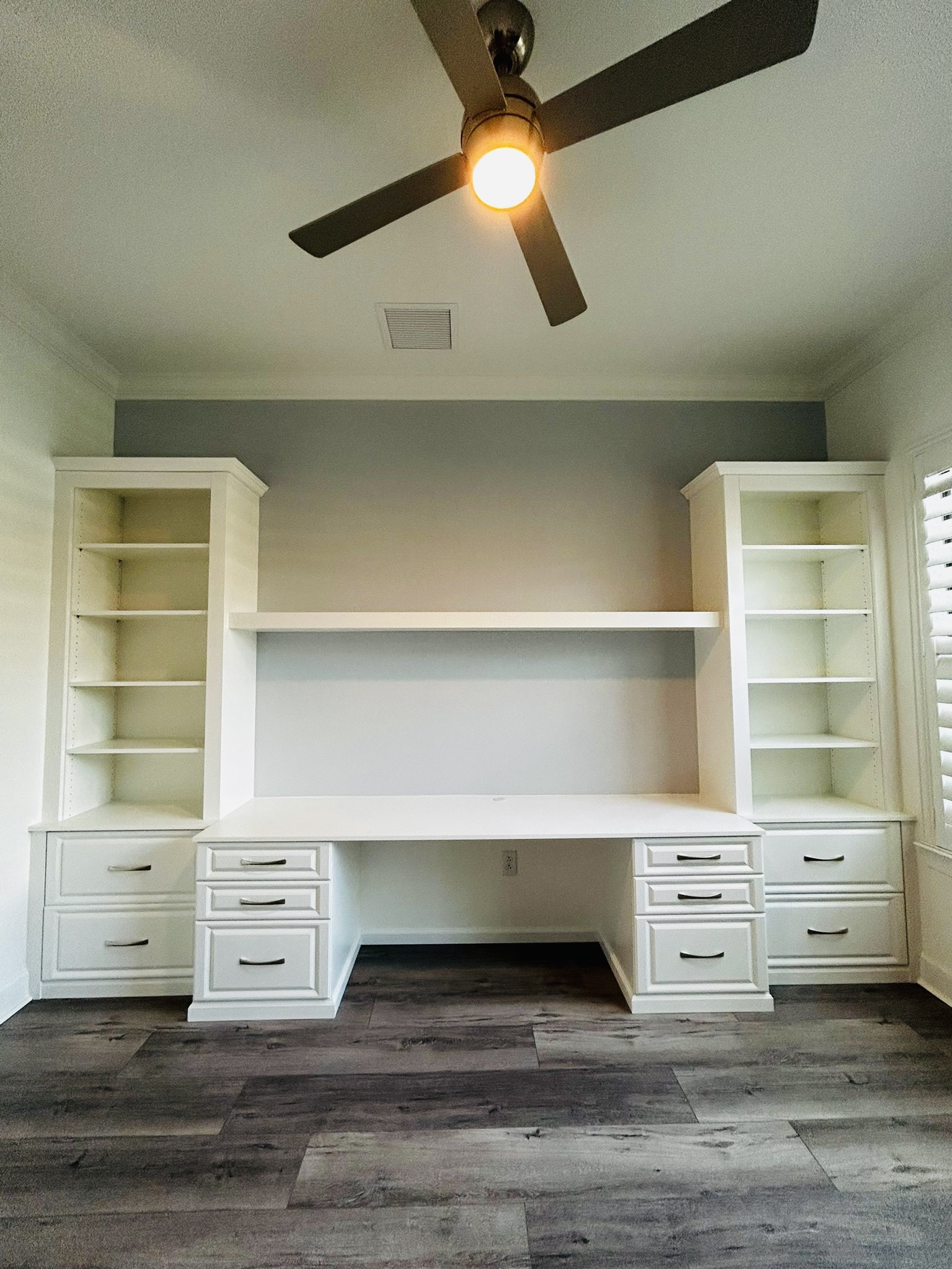 Pristine white custom walk-in closet with full hanging, shelving, and drawer zones in Bradenton FL by Dream Closets LLC