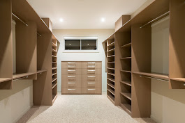 Walk-in wardrobe with natural wood built-ins