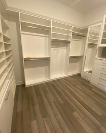 White walk-in closet with shelving and hanging rods