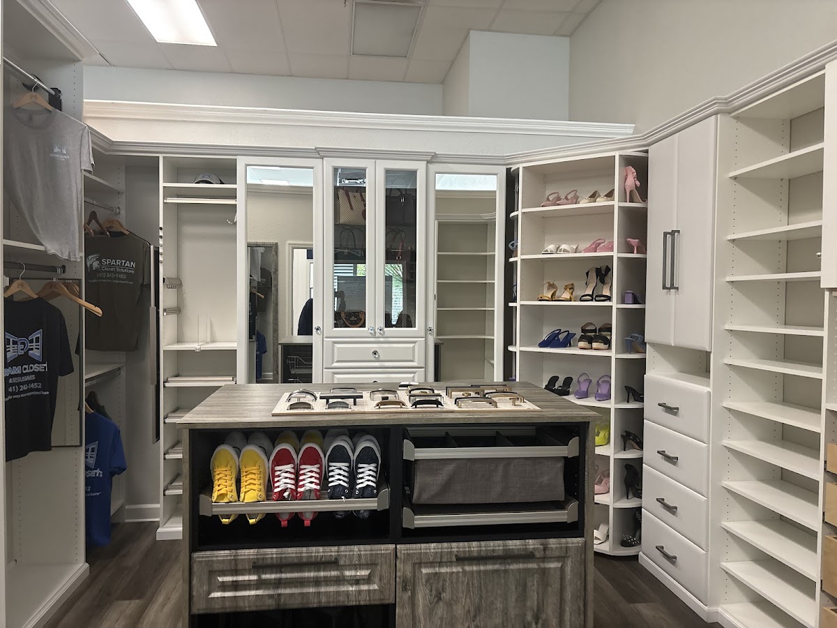 Luxury custom walk-in closet with center island, mirrors, and premium hardware by Dream Closets LLC in Sarasota FL